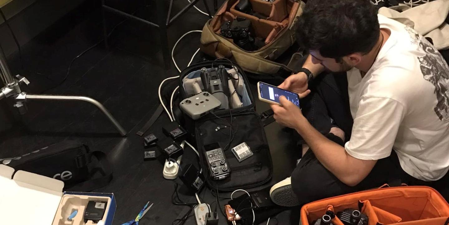 Журналист собирает аппаратуру для новостной съемки