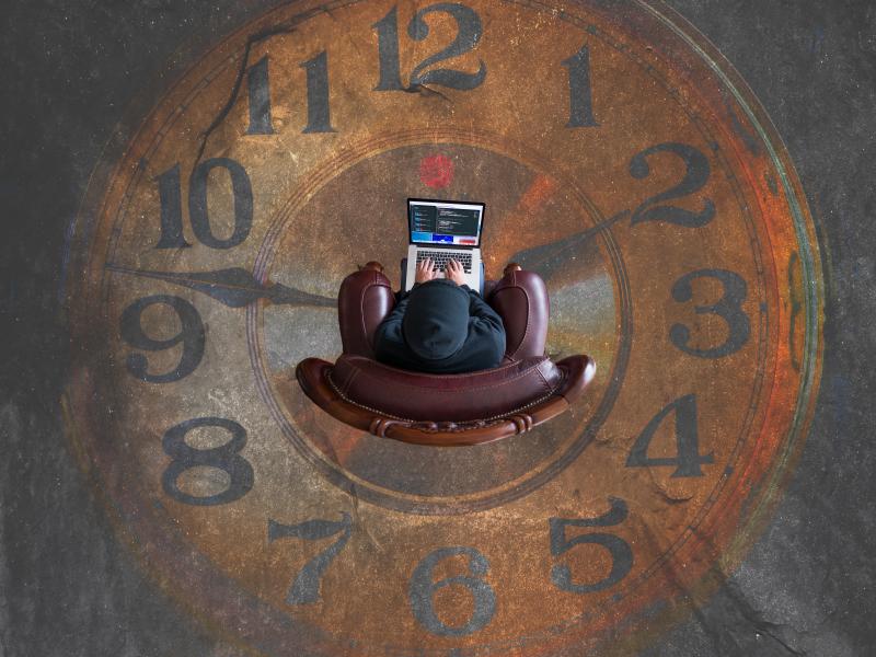 Journalist working over the image of a clock