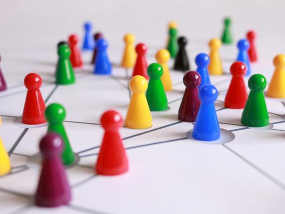 Multicolored game pieces on a map showing lines between them