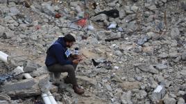 Photo of a journalist in ruins in Gaza