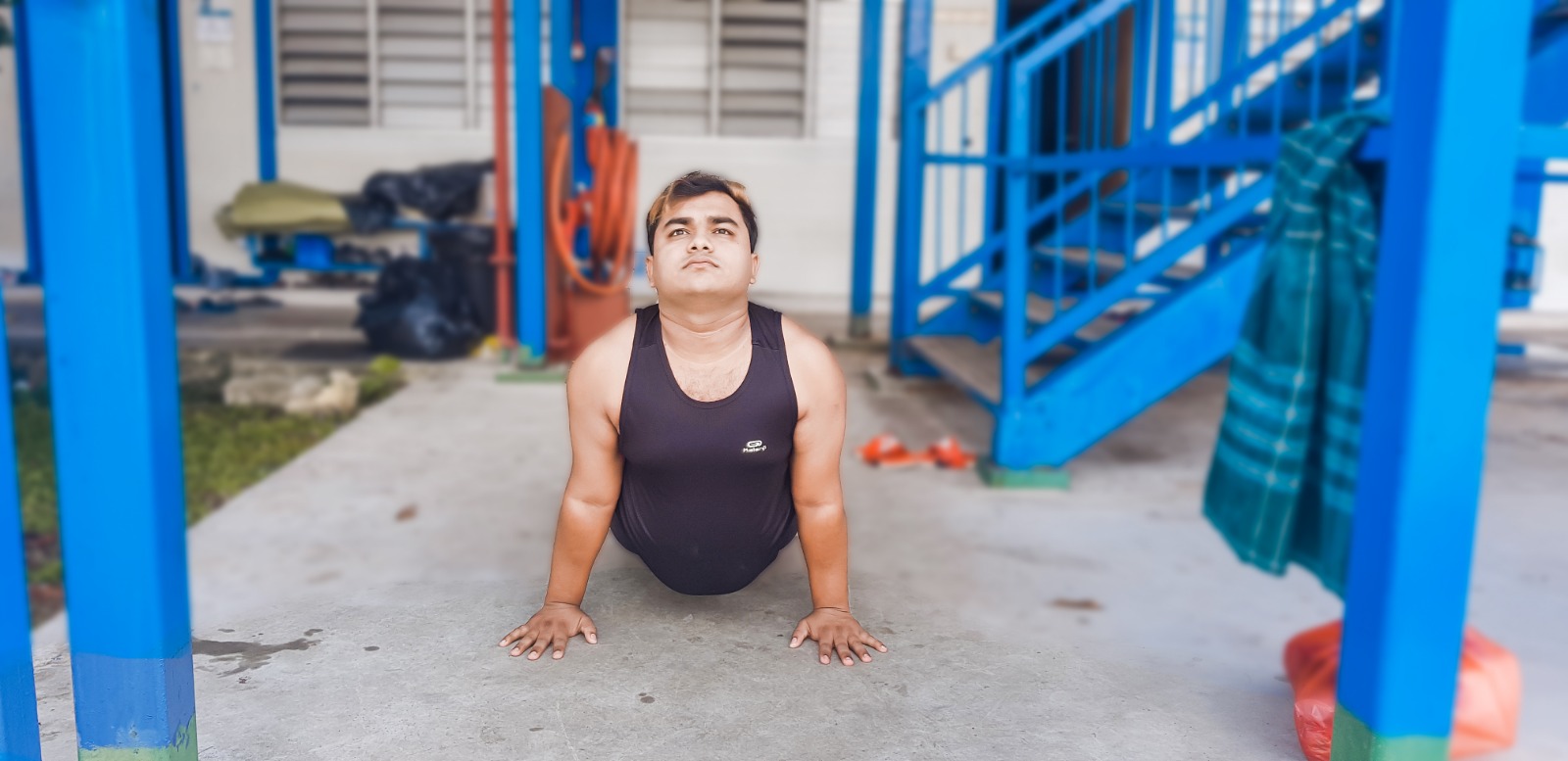 Islam Rockybul does yoga in the dorms. 