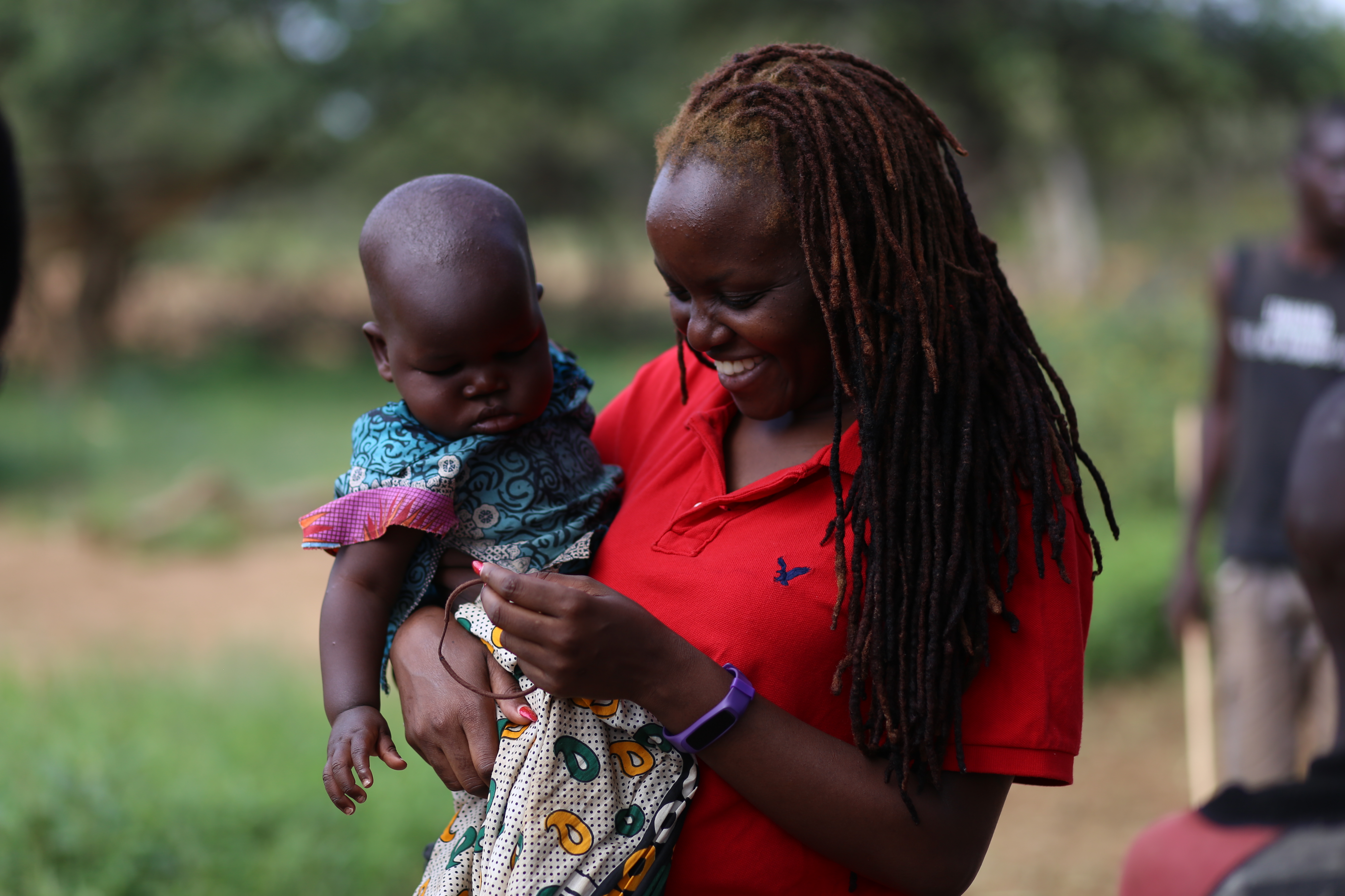 Okeyo holds a baby in West Pokot County