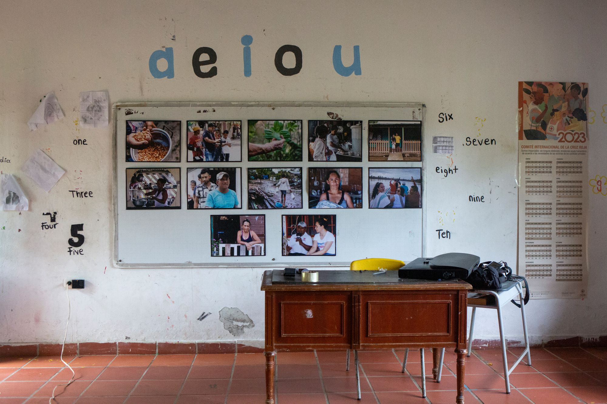 A pop-up gallery of photos taken by El Cuarto Mosquetero and Voces del Guayabero hangs in the school in Nuevo Colombia ahead of a community workshop on March 5, 2023.
