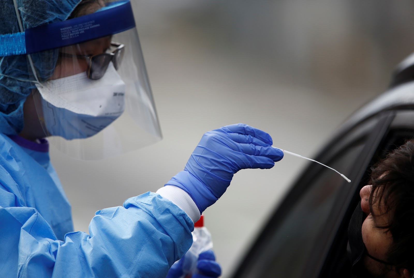 Nurse Tina Nguyen dons protective gear at a coronavirus testing site in Seattle, Washington, United States, during the COVID-19 outbreak (credit: REUTERS/Lindsey Wasson). 