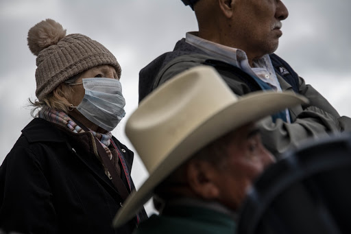 People wait in line at the San Ysidro border crossing hours after the US and Mexican governments announced travel restrictions between the two countries to prevent the spread of COVID-19 (credit: Christian Monterrosa). 