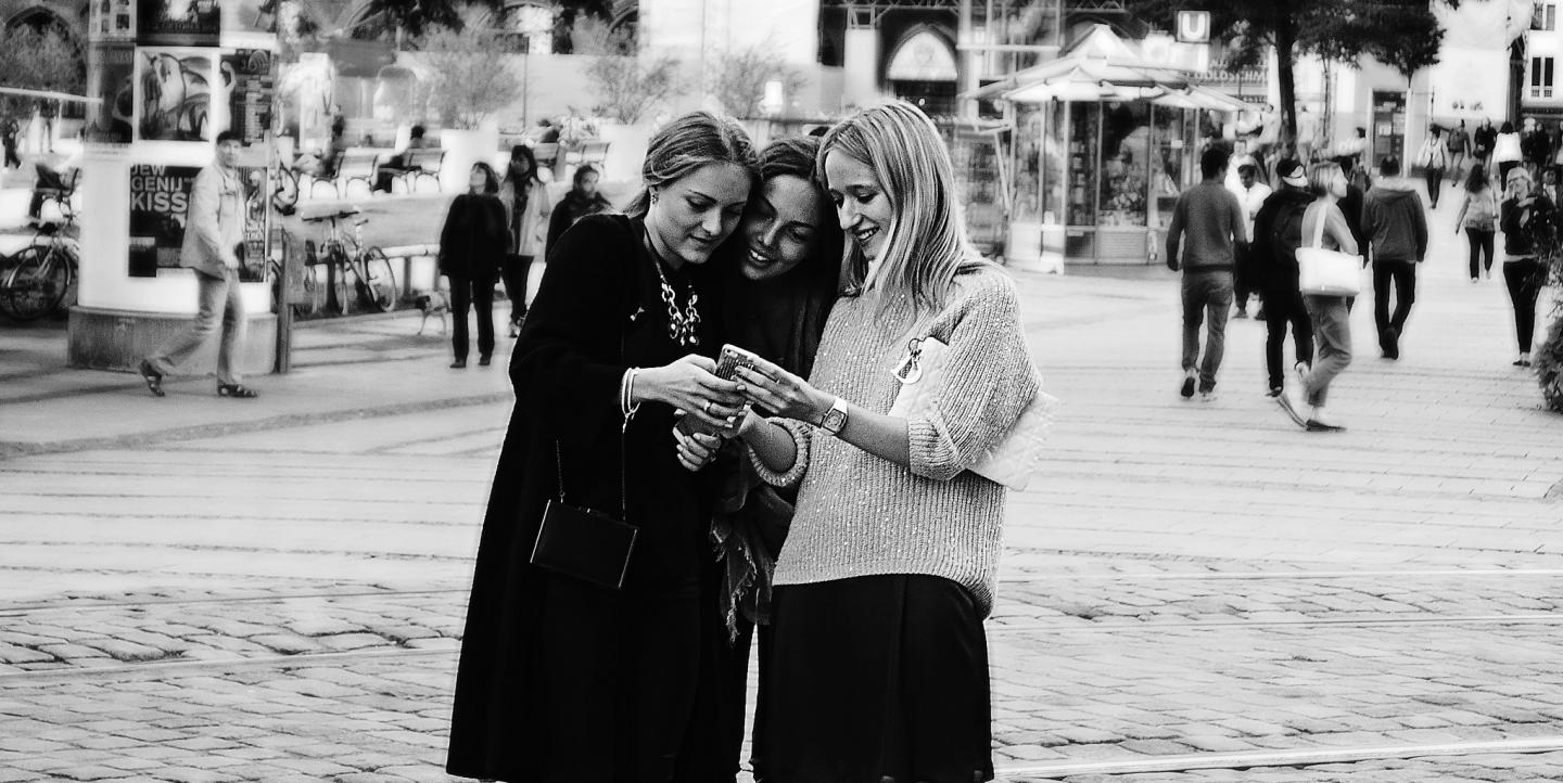 Women look at a phone