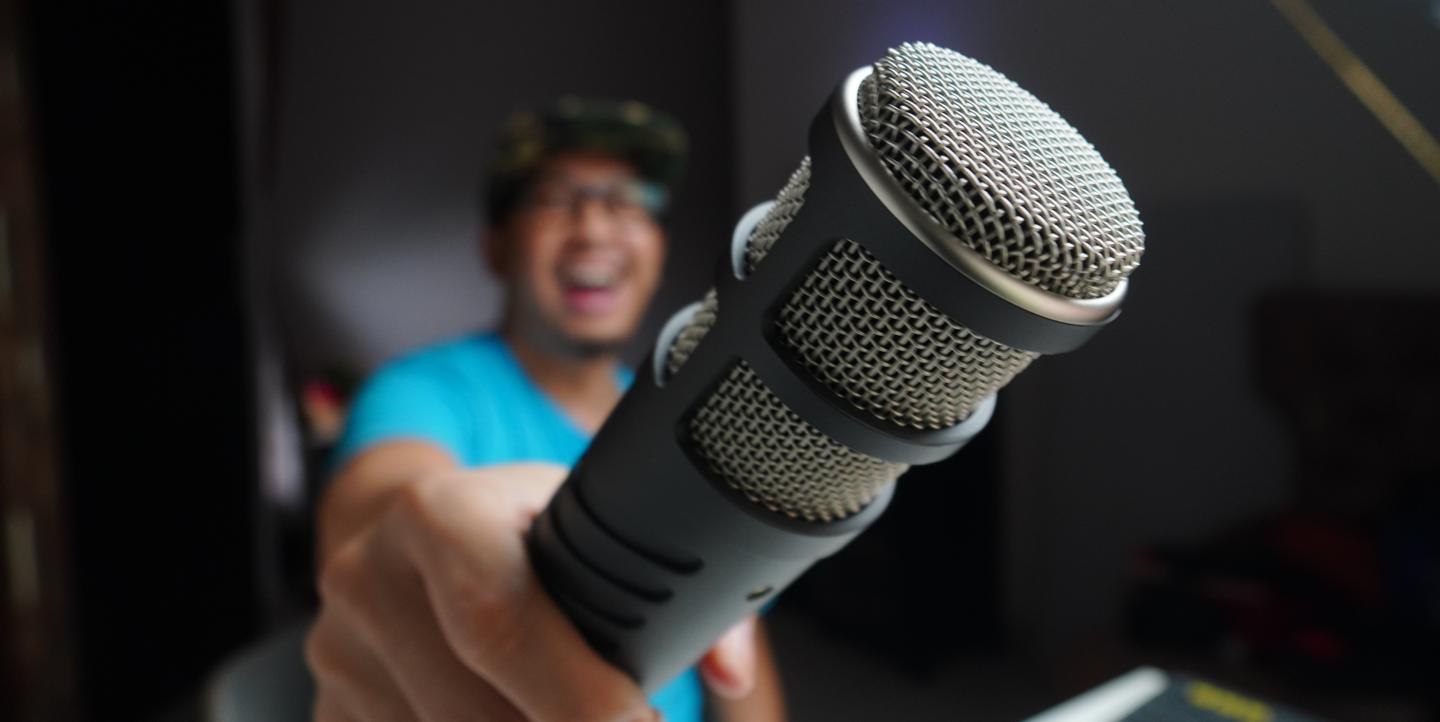 Man holding a microphone to the camera