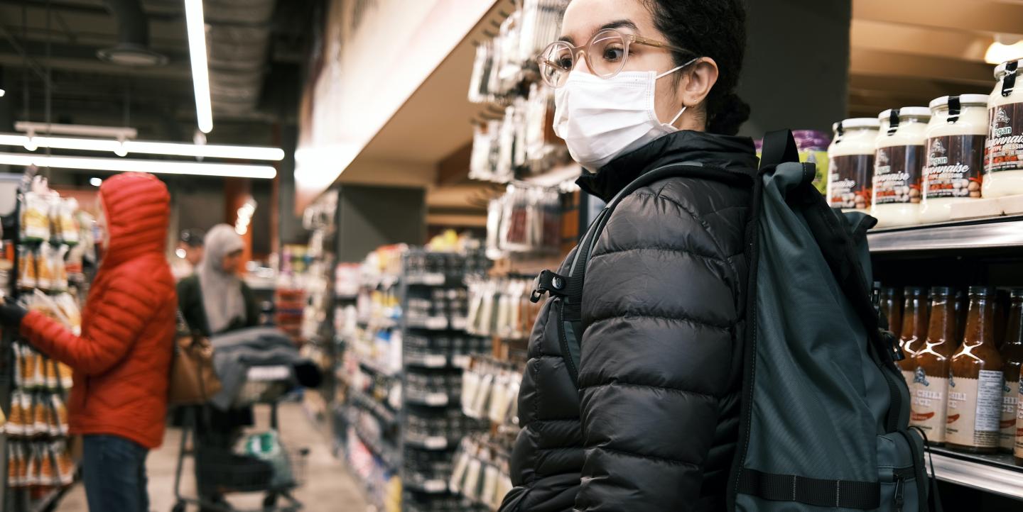 Pessoa com máscara no supermercado 