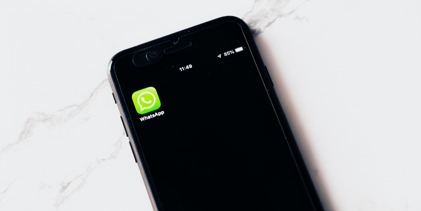 Phone screen with WhatsApp icon