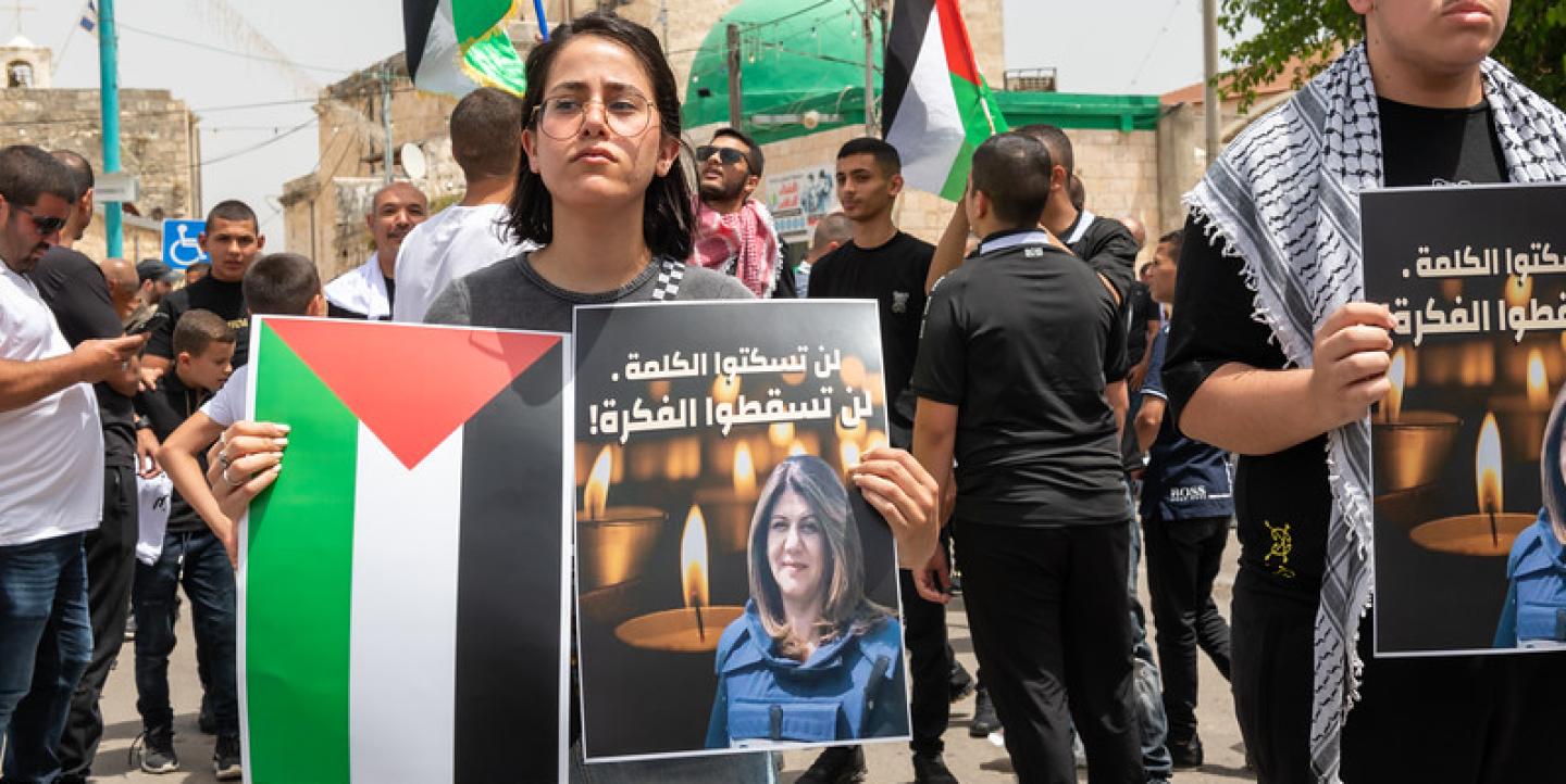 Protesters carrying photos of Shireen Abu Akleh