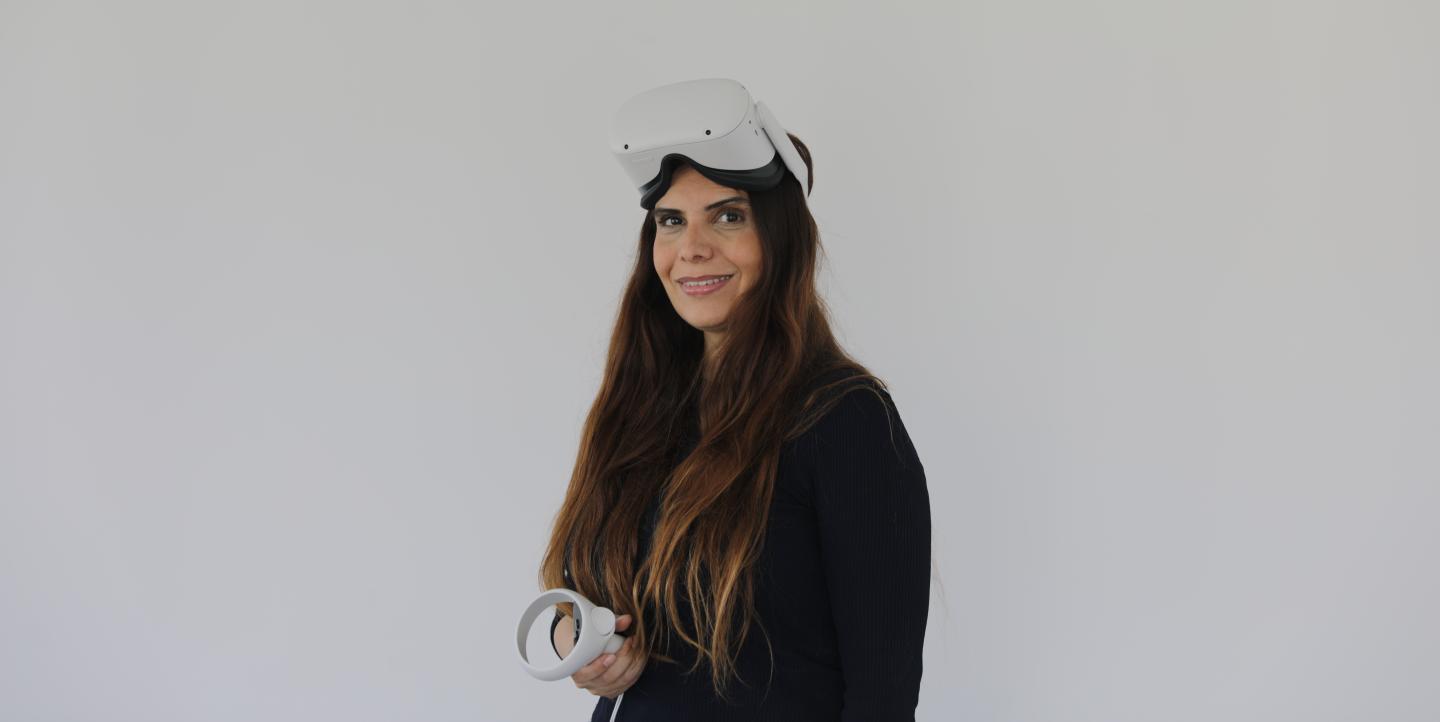 hadeel wearing VR headset in front of white background