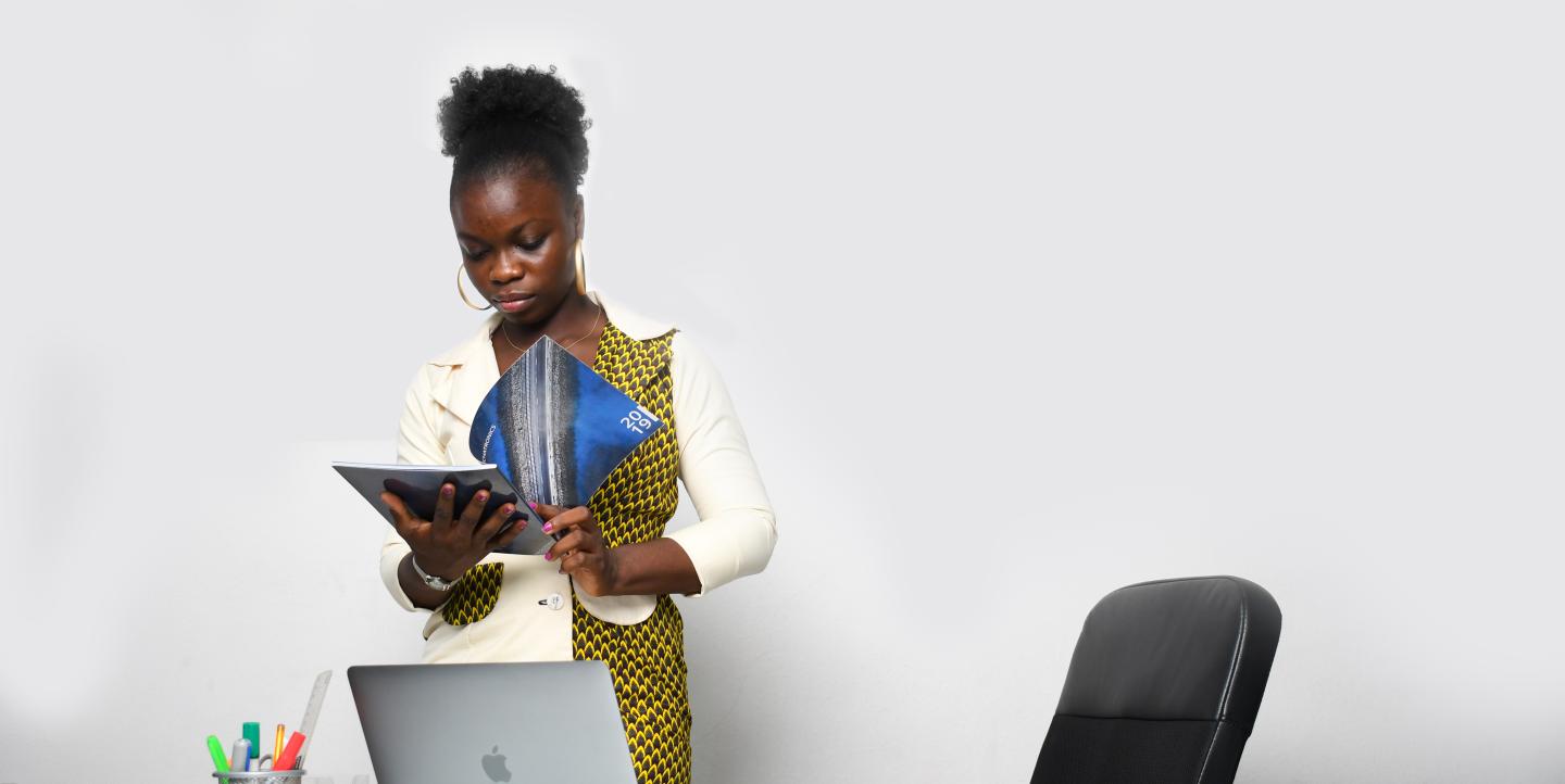 Black woman standing behind a desk