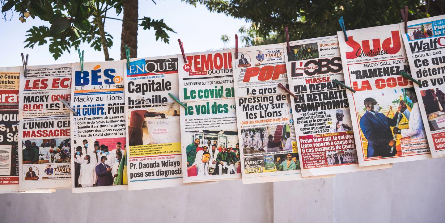 Newspapers hanging on a line in Dakar, Senegal