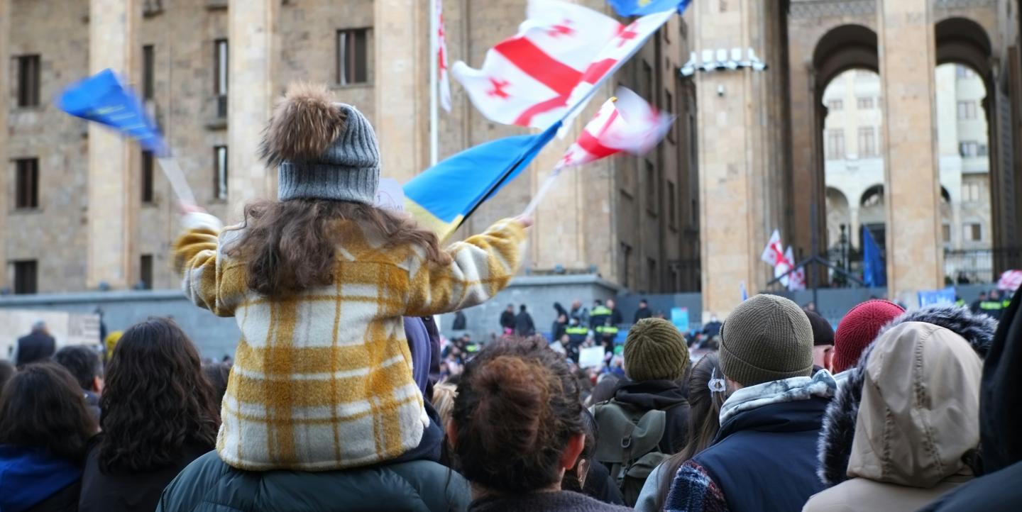 Little girl on her father's shoulders protesting against the proposed "Russian Law" in Georgia.