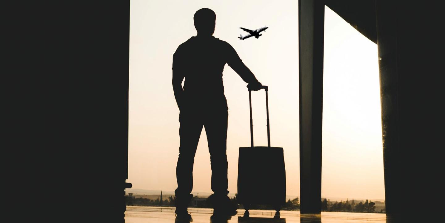 Man standing in silhouette at an airport