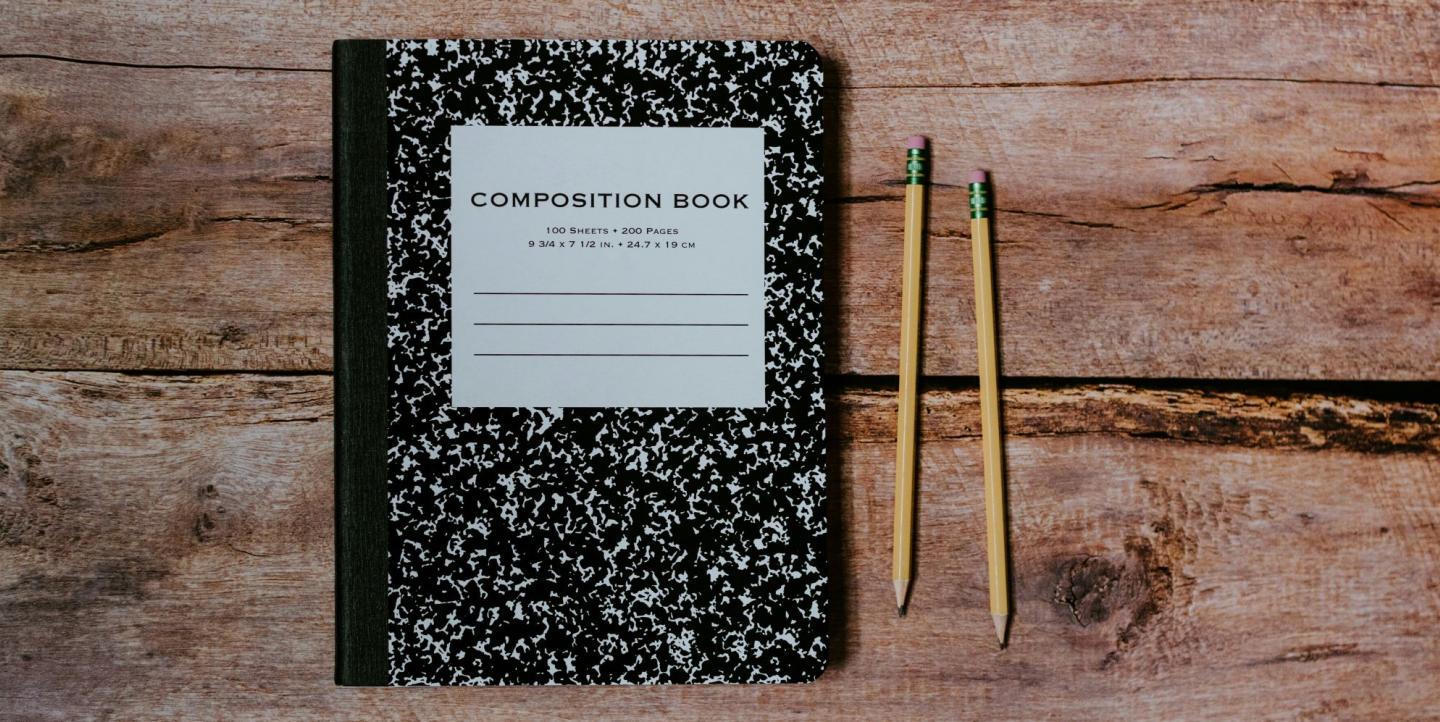 Composition notebook and two number two pencils دفتر تدوين وقلمان