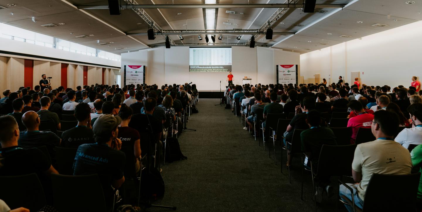 A large group of people sitting at a conference.