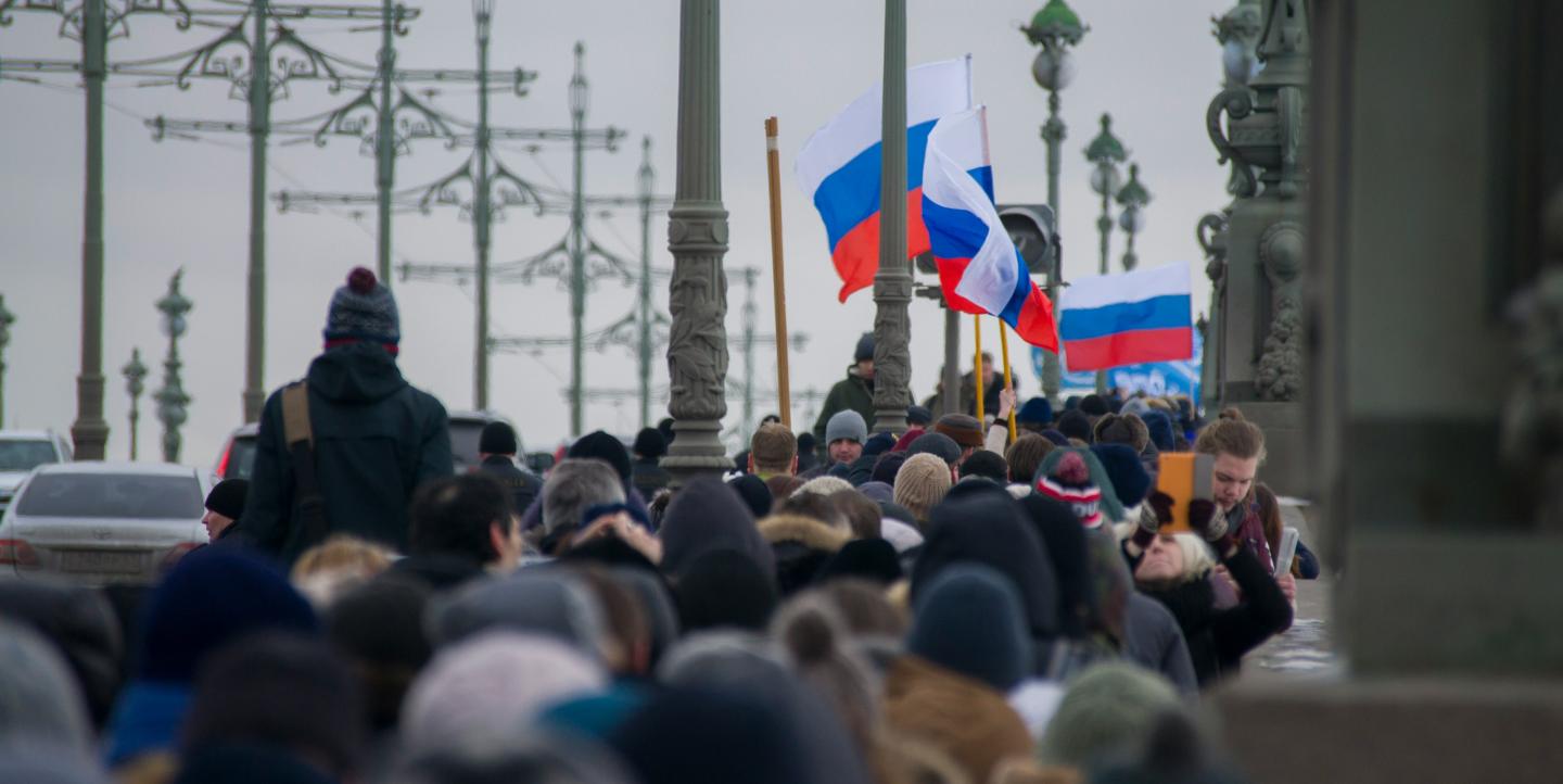 Crowd waving Russian flags at a protest against the arrest of Alexei Navalny