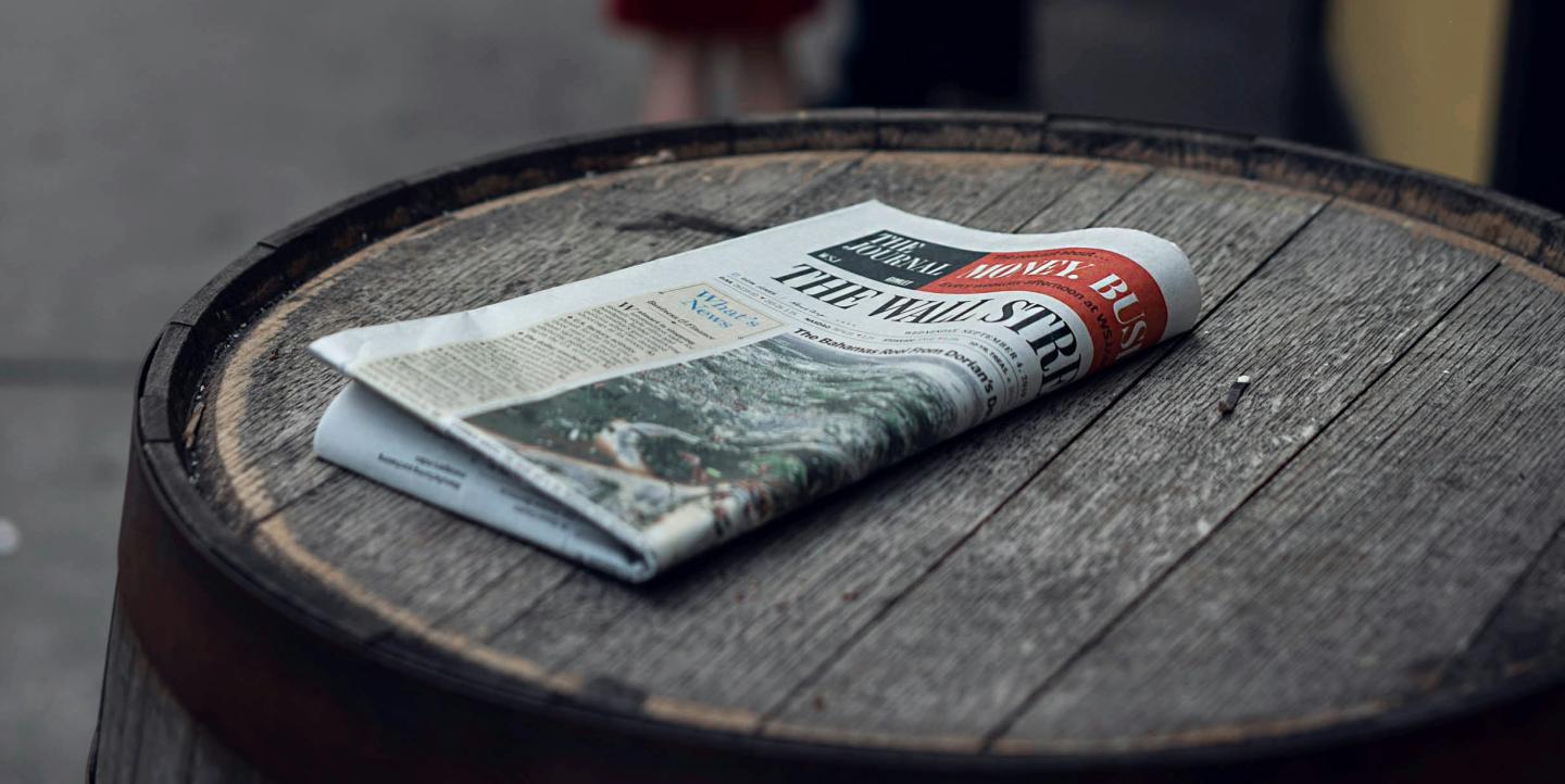 The Wall Street Journal on top of a wooden barrel