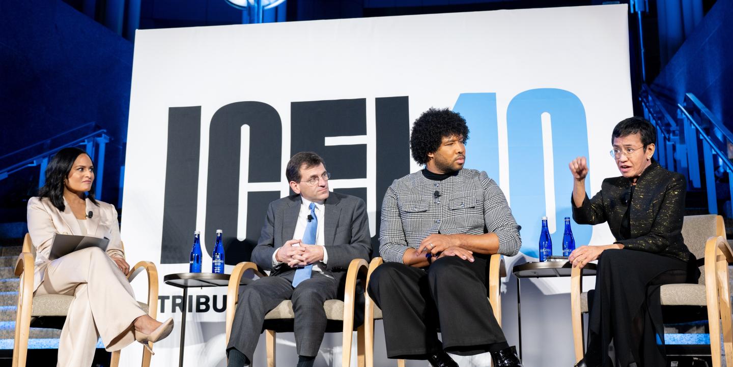 Ressa, Baker, Daniela and Walker on stage before a sign reading "ICFJ@40"