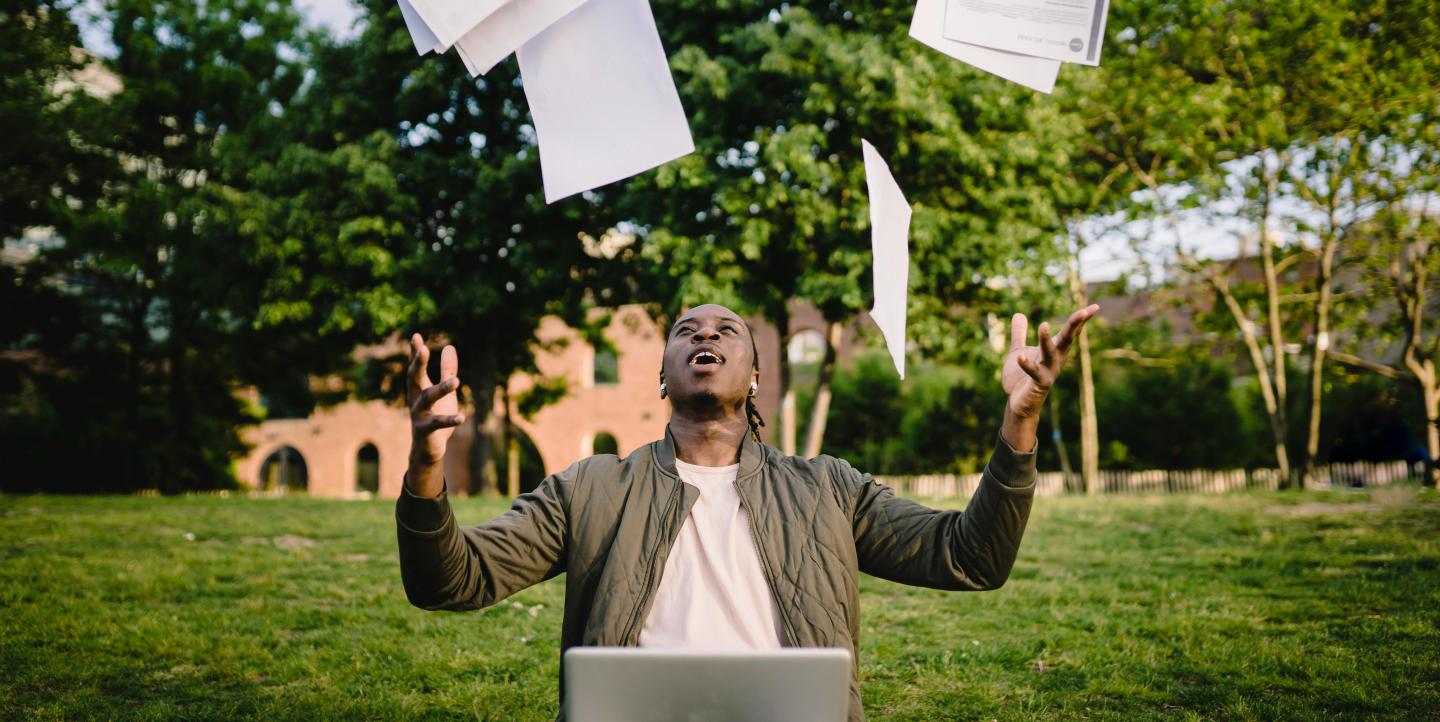 Man throws papers in the air