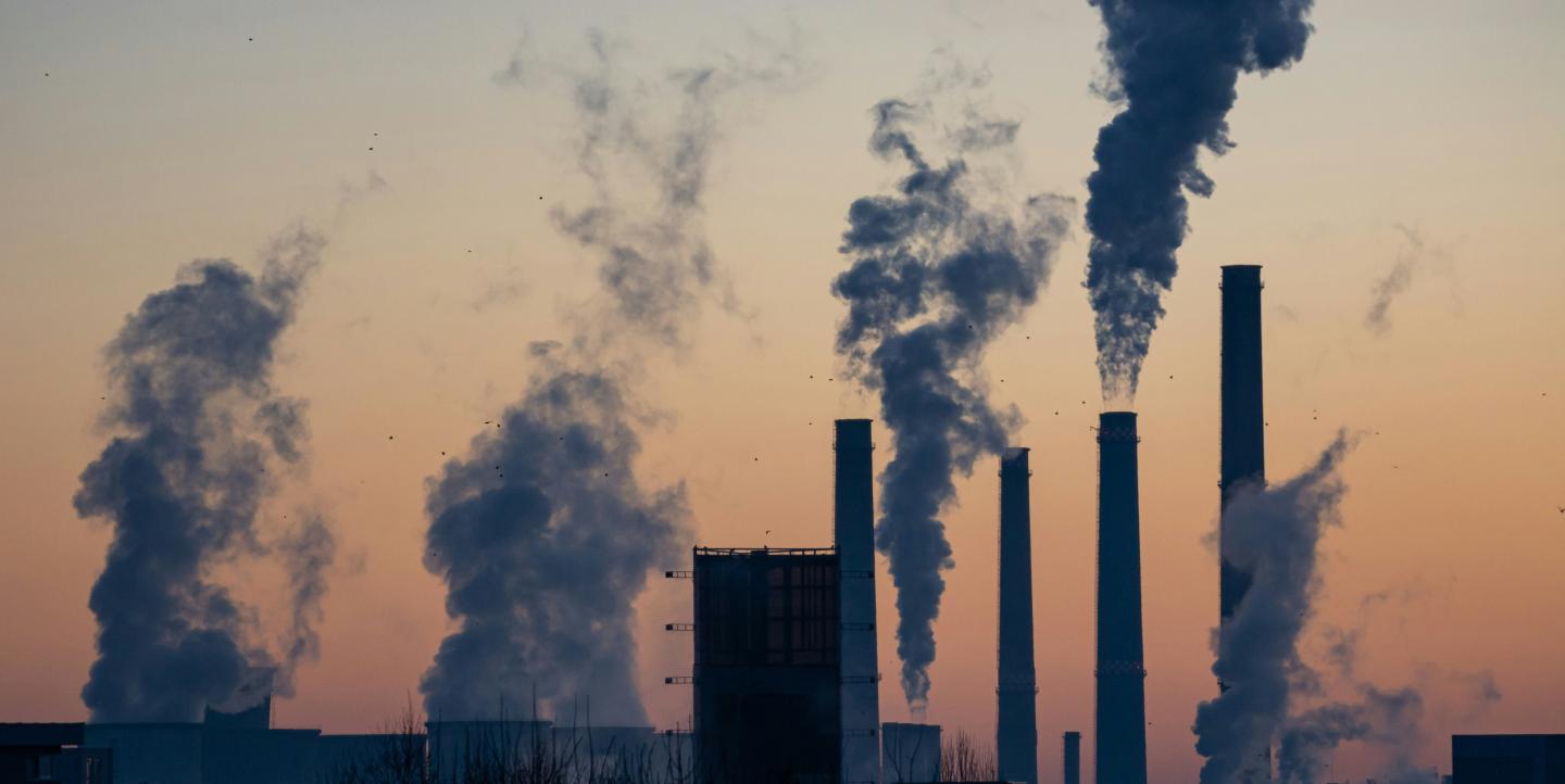 Steam and smoke being blown into the sky from factories