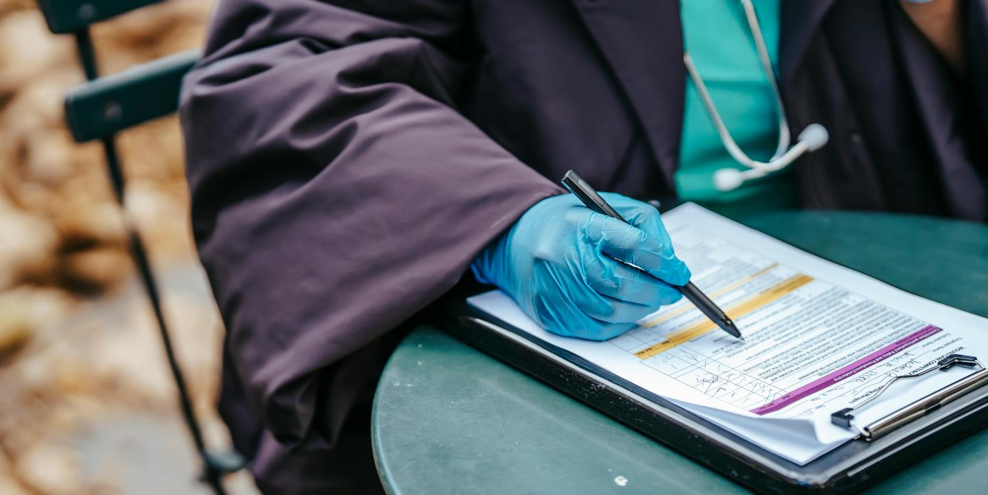 A doctor filling out a health form