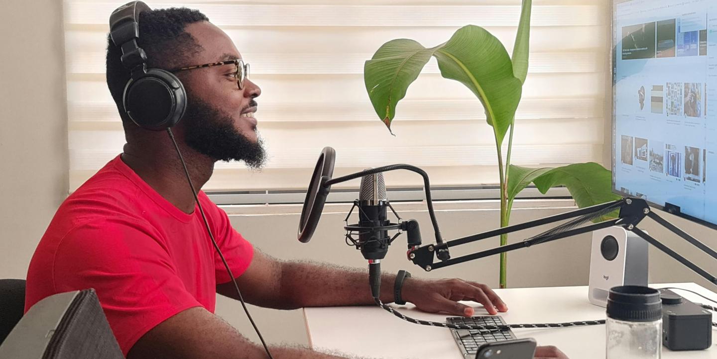 A man sitting in front of podcast equipment