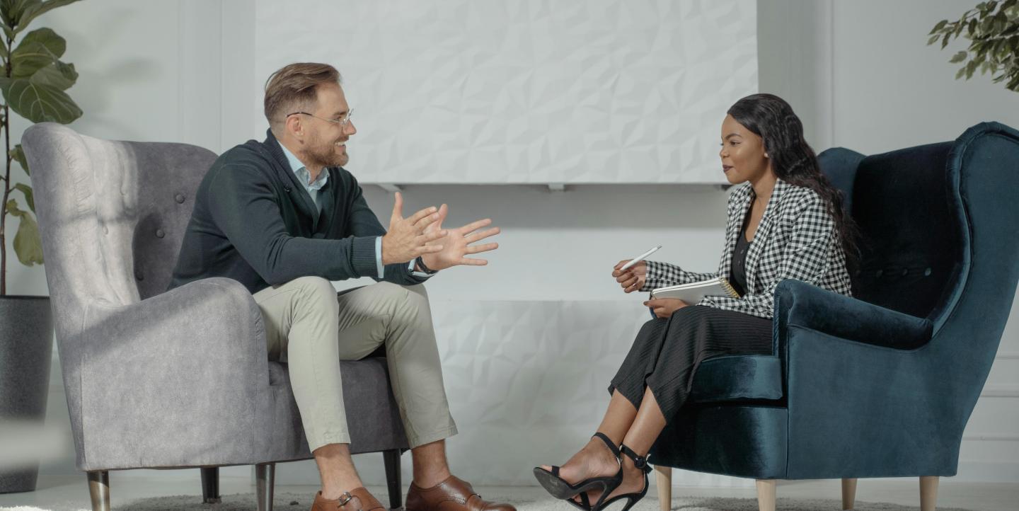 A woman interviewing a man
