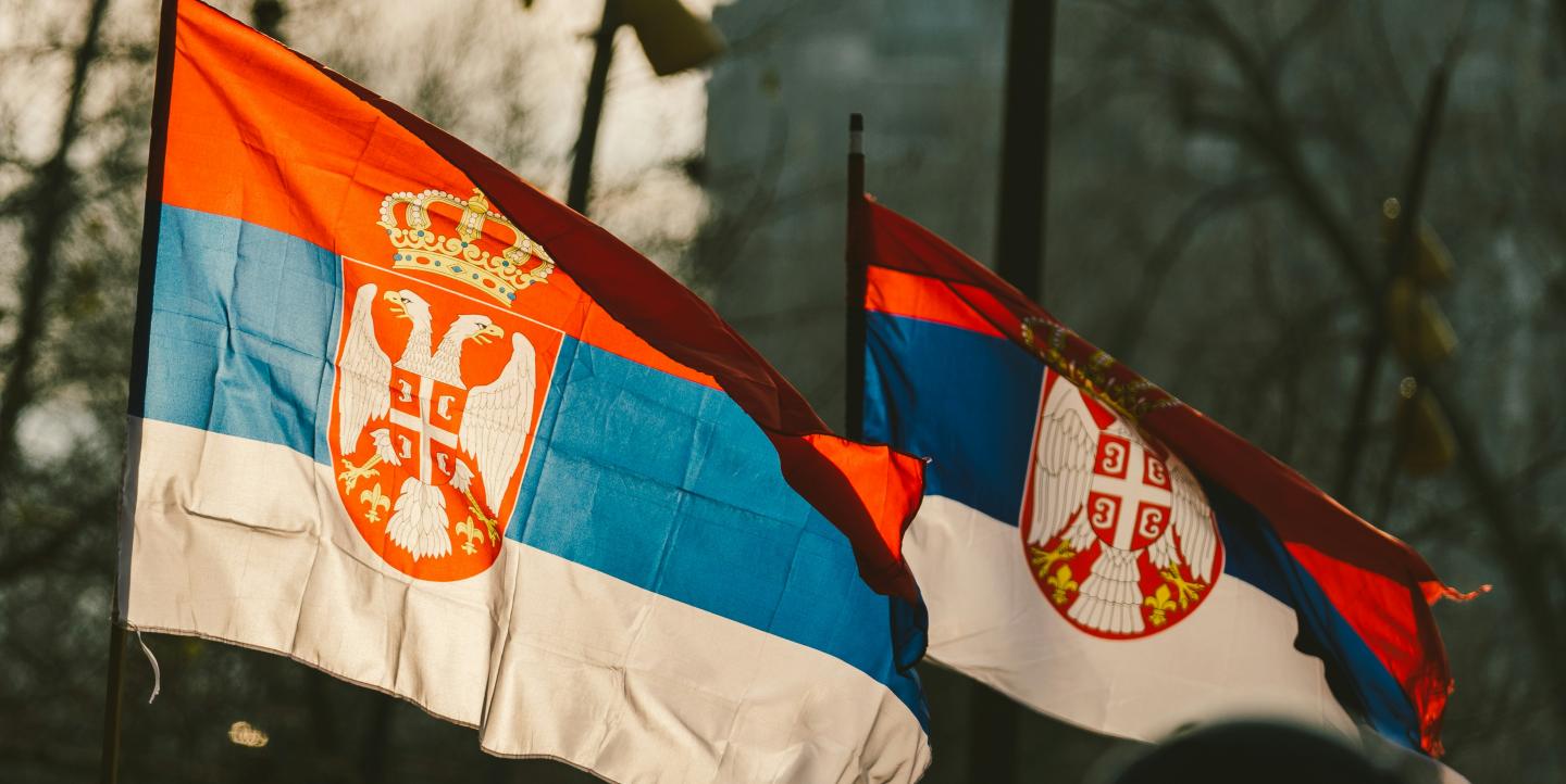 Two Serbian flags blowing in the wind.