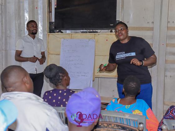 Harriet Atyang presenting to community members.