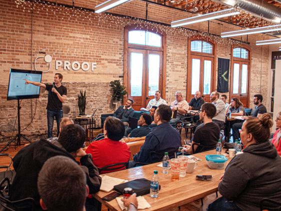 A man giving a presentation to audience of people.