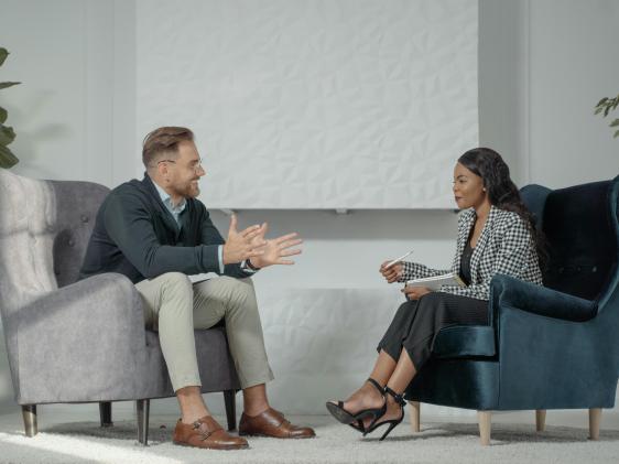 A woman interviewing a man
