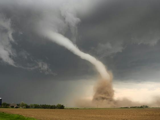 A large tornado coming out of the sky.