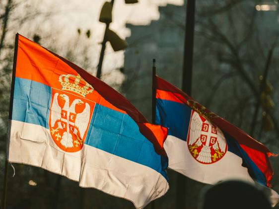 Two Serbian flags blowing in the wind.