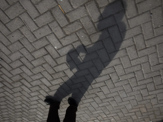 A man's shadow captured on the ground
