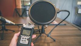 Voice recorder in front of microphone