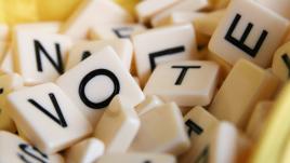 Scrabble pieces that spell out the word vote. 
