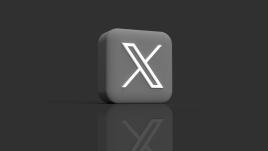 X logo on a grey dice and black background