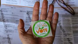 Hand holding "I Voted" Sticker