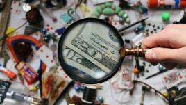 Magnifying glass looking at money