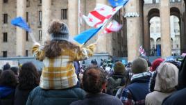 Little girl on her father's shoulders protesting against the proposed "Russian Law" in Georgia.