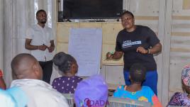 Harriet Atyang presenting to community members.