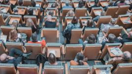 People sitting in chairs at a conference