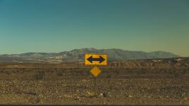 Sign pointing tow ways in the desert