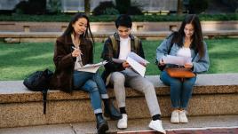 Students sitting outside and studying.