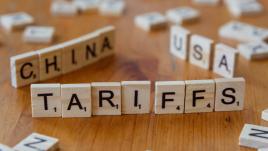 Scrabble pieces that spell out tariffs, china, USA.