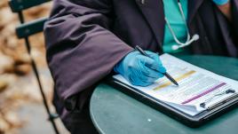 A doctor filling out a health form