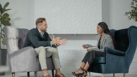 A woman interviewing a man